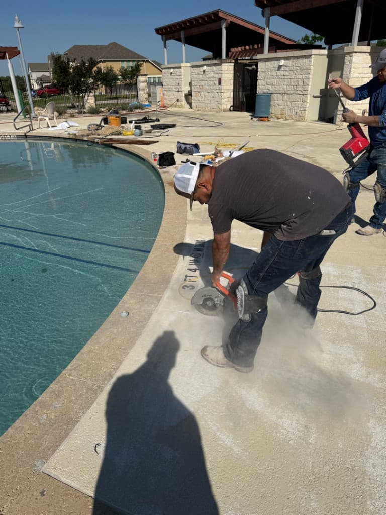 Crew cutting pool deck to access underground plumbing — Georgetown