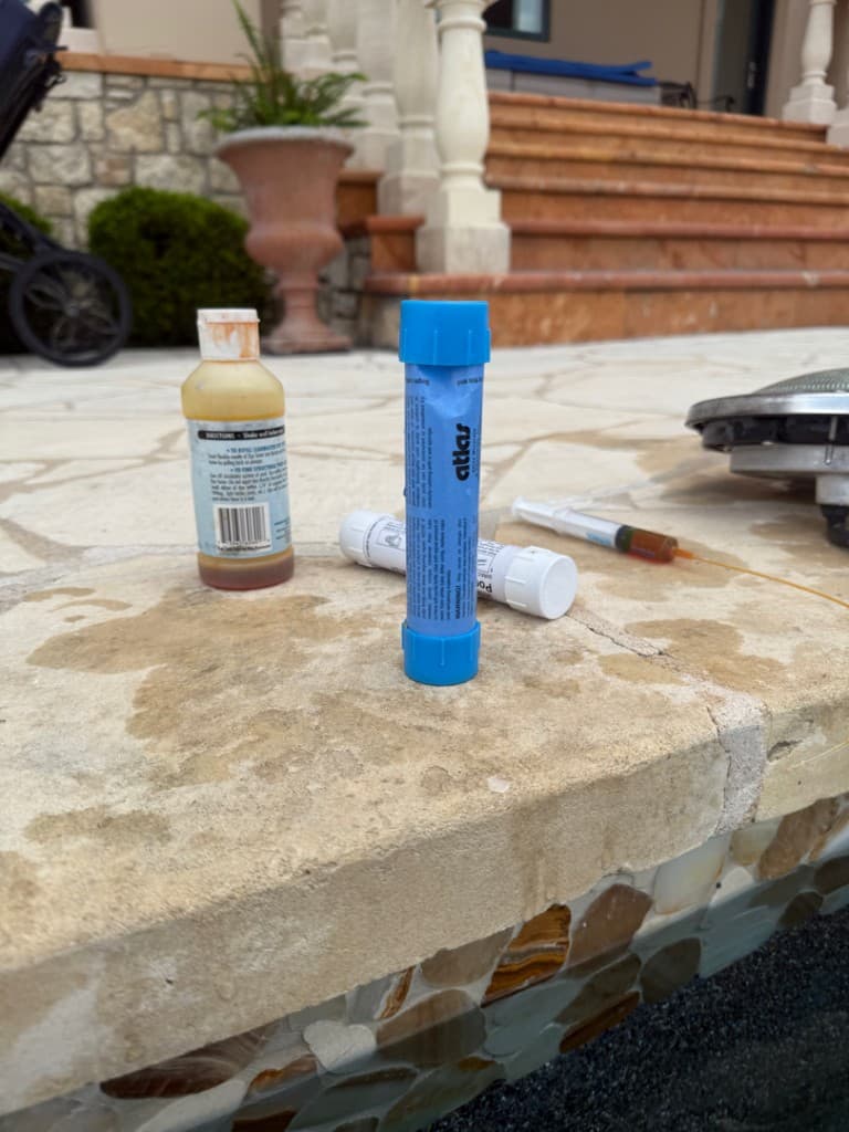 Dye testing supplies laid out on pool coping during leak detection — Lago Vista