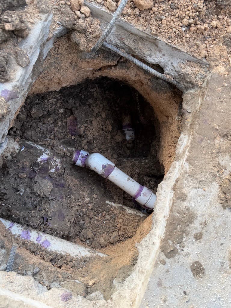 Underground PVC pipe repaired with purple primer — Leander