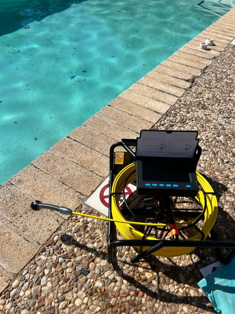 Diver performing underwater pool leak inspection in Central Texas