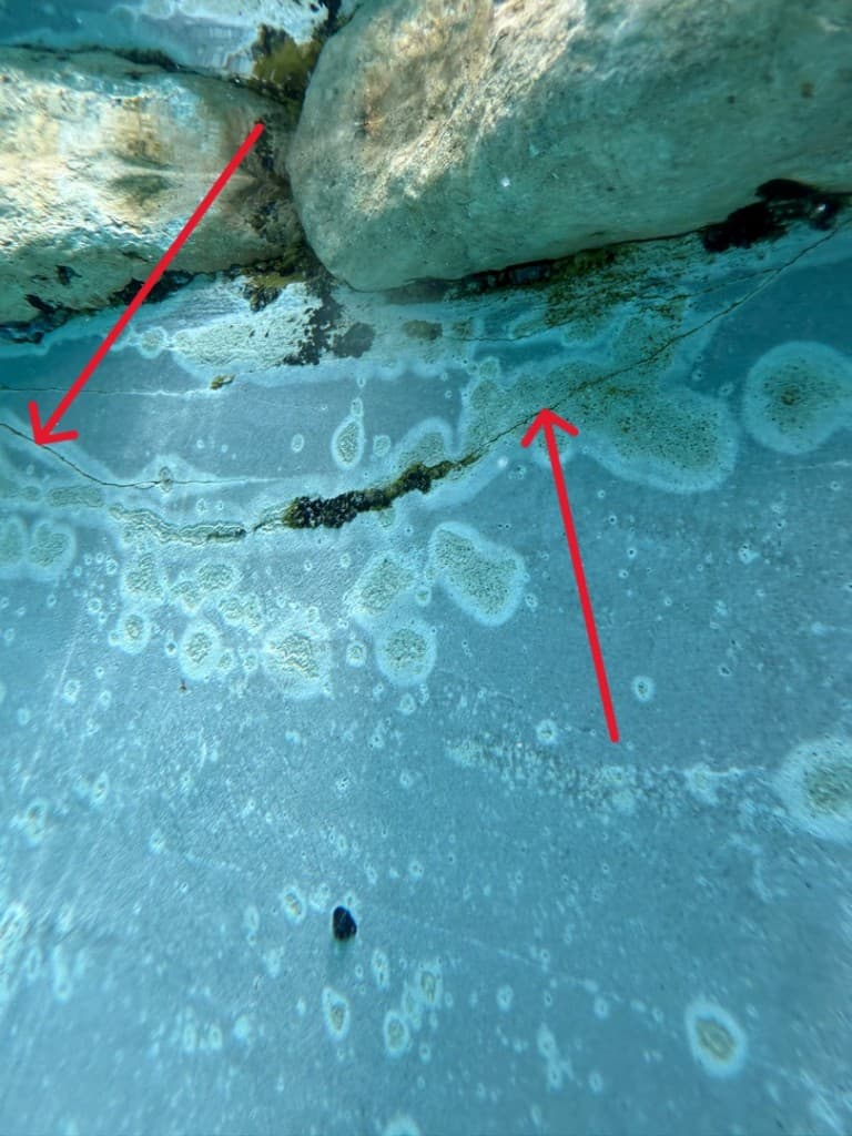 Diver performing underwater pool leak inspection in Central Texas
